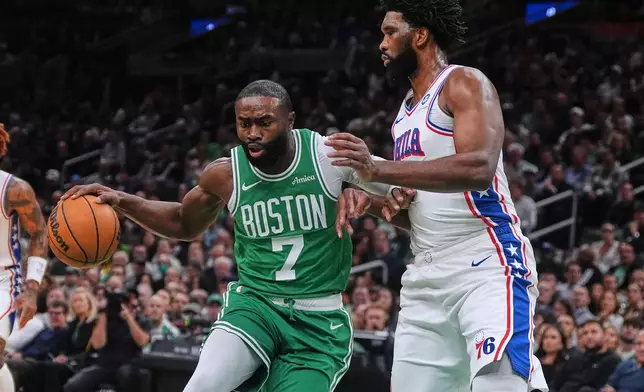 FILE - Boston Celtics forward Jaylen Brown (7) drives to the basket against Philadelphia 76ers center Joel Embiid, right, during the first half of an NBA basketball game, Wednesday, Oct. 22, 2025, in Boston. (AP Photo/Charles Krupa,File)