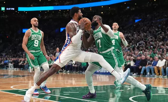 FILE - Philadelphia 76ers forward Paul George (8) drives to the basket against Boston Celtics guard Jaylen Brown (7) during the second half of Game 2 of a first-round NBA playoffs basketball series, April 21, 2026, in Boston. (AP Photo/Charles Krupa, File)