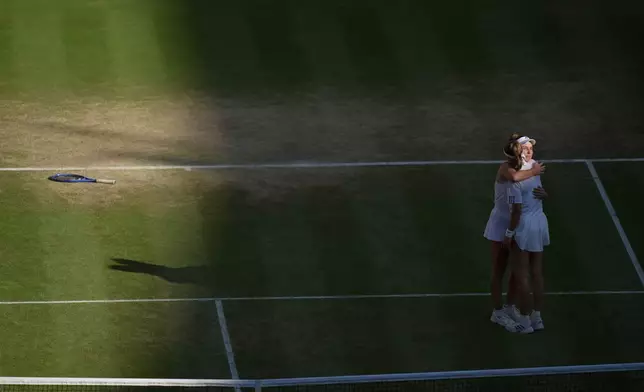 Linda Noskova of Czech Republic right, is embraced by Karolina Muchova of Czech Republic, after she won the women's singles final at Wimbledon Tennis Championships in London, Saturday, July 11, 2026. (AP Photo/Brian Inganga)