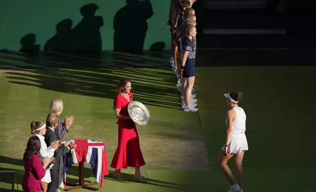 Kate Princess of Wales present the winners trophy to Linda Noskova of Czech Republic who defeated Karolina Muchova of Czech Republic in the women's singles final at Wimbledon Tennis Championships in London, Saturday, July 11, 2026. (AP Photo/Brian Inganga)