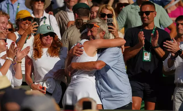 Linda Noskova of Czech Republic hugs a member of her team after winning the women's singles final at Wimbledon Tennis Championships in London, Saturday, July 11, 2026. (AP Photo/Kirsty Wigglesworth)
