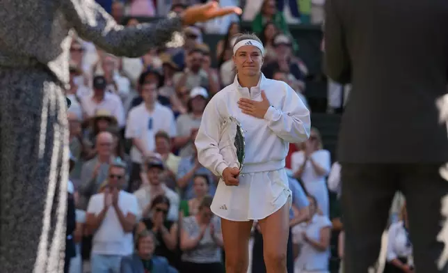 Karolina Muchova of Czech Republic reacts as she receives the trophy after losing to Linda Noskova of Czech Republic in the women's singles final at Wimbledon Tennis Championships in London, Saturday, July 11, 2026. (AP Photo/Kirsty Wigglesworth)