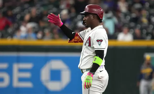 Arizona Diamondbacks' Geraldo Perdomo reacts after hitting a double against the Milwaukee Brewers in the first inning of a baseball game, Sunday, July 5, 2026, in Phoenix. (AP Photo/Rick Scuteri)