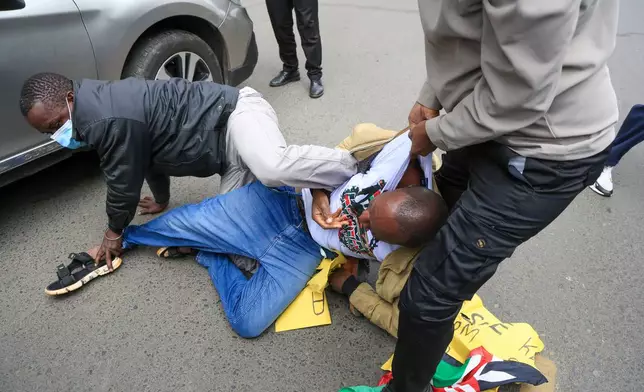 Plain-clothed police officers arrest protesters during a demonstration marking a day that is historically associated with the pro-democracy protests of the 1990s that ushered in multipartyism in Nairobi, Kenya, Tuesday, July 7, 2026. (AP Photo/Andrew Kasuku)