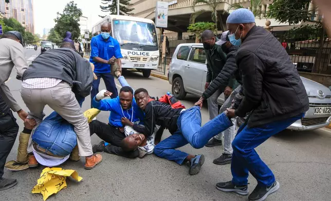 Kenyan plain clothes police officers arrest protesters, during a demonstration marking a day that is historically associated with the pro-democracy protests of the 1990s that ushered in multipartyism, in Nairobi, Kenya, Tuesday, July 7, 2026. (AP Photo/Andrew Kasuku)
