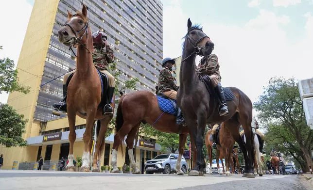 Kenyan police on a horseback patrol during a demonstration marking a day that is historically associated with the pro-democracy protests of the 1990s that ushered in multipartyism, in Nairobi, Kenya, Tuesday, July 7, 2026. (AP Photo/Andrew Kasuku)