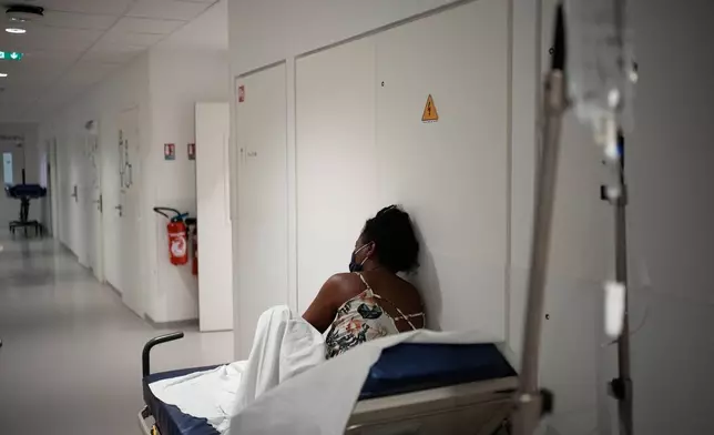A patient waits before being treated at the emergency department of the Paris-Saclay Hospital, outside Paris, Tuesday June 30, 2026. (AP Photo/Christophe Ena )