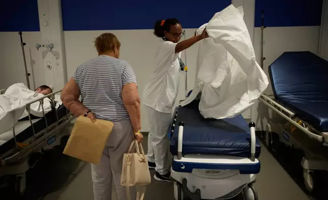 A nurse prepares a bed at the emergency department of the Paris-Saclay Hospital, outside Paris, Tuesday June 30, 2026. (AP Photo/Christophe Ena )
