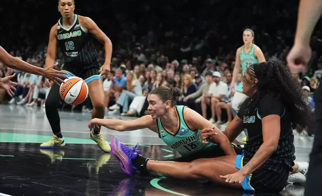 New York Liberty's Pauline Astier (18) fights for control of the ball with Chicago Sky's Kamilla Cardoso (10) during the second half of a WNBA basketball game Wednesday, July 22, 2026, in New York. (AP Photo/Frank Franklin II)