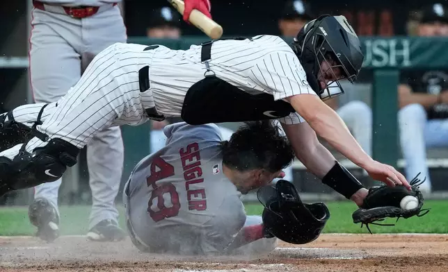 Boston Red Sox's Anthony Seigler (48) scores on a wild pitch by Chicago White Sox starting pitcher Davis Martin as catcher Kyle Teel catches the ball during the third inning of a baseball game in Chicago, Wednesday, July 8, 2026. (AP Photo/Nam Y. Huh)