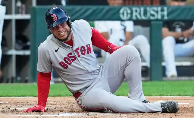 Boston Red Sox's Willson Contreras reacts after an injury during the third inning of a baseball game against the Chicago White Sox in Chicago, Wednesday, July 8, 2026. (AP Photo/Nam Y. Huh)