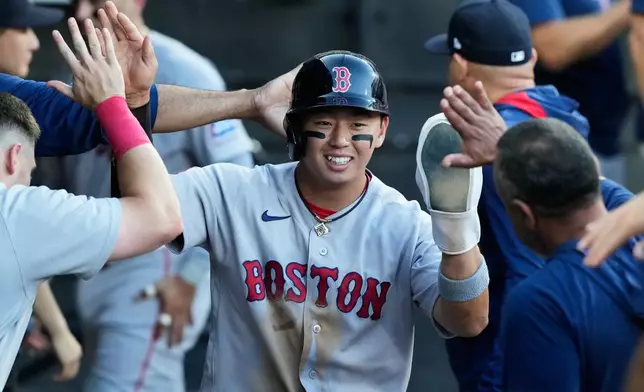 Boston Red Sox's Tsung-Che Cheng of Taiwan, celebrates with teammates after scoring on a one-run double by Ceddanne Rafaela during the third inning of a baseball game against the Chicago White Sox in Chicago, Wednesday, July 8, 2026. (AP Photo/Nam Y. Huh)