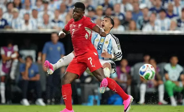 Switzerland's Breel Embolo (7) battles for the ball with Argentina's Leandro Paredes (5) during the World Cup quarterfinal soccer match between Argentina and Switzerland in Kansas City, Mo., Saturday, July 11, 2026. (AP Photo/Ed Zurga)