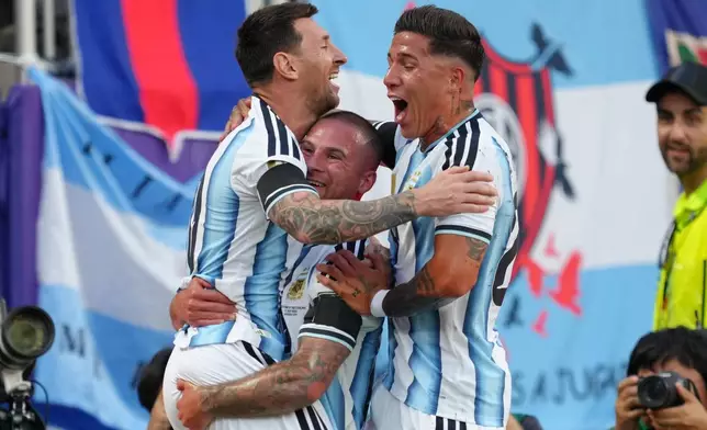 Argentina's Alexis Mac Allister, center, celebrates after scoring his side's opening goal with teammates Argentina's Lionel Messi, left, and Argentina's Enzo Fernandez during the World Cup quarterfinal soccer match between Argentina and Switzerland in Kansas City, Mo., Saturday, July 11, 2026. (AP Photo/Ed Zurga)
