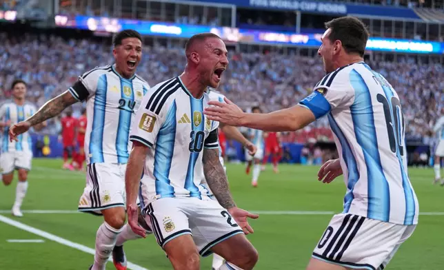 Argentina's Alexis Mac Allister, center, celebrates scoring their first goal with Lionel Messi during the World Cup quarterfinal soccer match between Argentina and Switzerland in Kansas City, Mo., Saturday, July 11, 2026. (AP Photo/Abbie Parr)