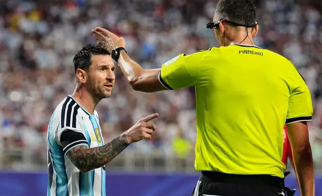 Argentina's Lionel Messi, left, talks to referee Joao Pinheiro, of Portugal, during the World Cup quarterfinal soccer match against Switzerland in Kansas City, Mo., Saturday, July 11, 2026. (AP Photo/Charlie Riedel)