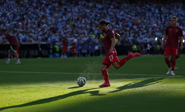 Switzerland's Ricardo Rodriguez (13) warms up prior to the World Cup quarterfinal soccer match between Argentina and Switzerland in Kansas City, Mo., Saturday, July 11, 2026. (AP Photo/Abbie Parr)