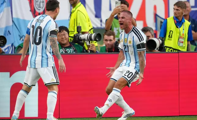 Argentina's Alexis Mac Allister (20) celebrates with teammate Lionel Messi (10) after scoring his side's opening goal during the World Cup quarterfinal soccer match between Argentina and Switzerland in Kansas City, Mo., Saturday, July 11, 2026. (AP Photo/Ed Zurga)