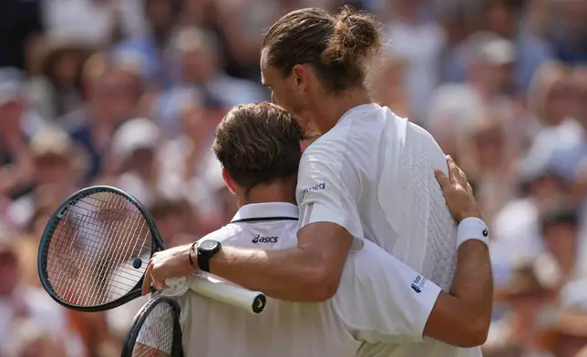 Alexander Zverev of Germany, right, speaks to Arthur Fery of Britain at the net after Zverev won their men's singles semifinal match at the Wimbledon Tennis Championships in London, Friday, July 10, 2026. (AP Photo/Kirsty Wigglesworth)