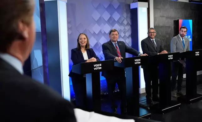 From podium left, U.S. Senate candidates Shenna Bellows, Troy Jackson, Dr. Nirav Shah, and Jordan Wood talk with moderator Phil Hirschkorn at WCSH-6 before a televised debate at the WCSH-6 studio Thursday, July 16, 2026, in Portland, Maine. (AP Photo/Robert F. Bukaty)