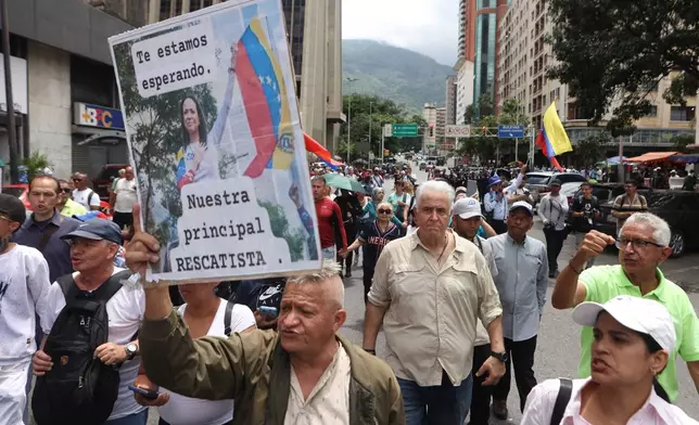Trade union members march to demand that the government announce a timetable for presidential elections in Caracas, Venezuela, Wednesday, July 8, 2026. 2026. (AP Photo/Pedro Mattey)