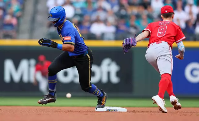 Seattle Mariners' Julio Rodríguez advances to third on a throwing error by Los Angeles Angels infielder Nolan Schanuel in the first inning of a baseball game Thursday, July 2, 2026, in Seattle. (AP Photo/Kevin Ng)