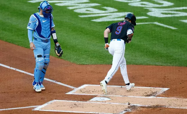 Kansas City Royals catcher Carter Jensen, left, watches as New York Mets' A.J. Ewing (9) crosses home plate to score after hitting a home run during the first inning of a baseball game, Wednesday, July 8, 2026, in New York. (AP Photo/Noah K. Murray)