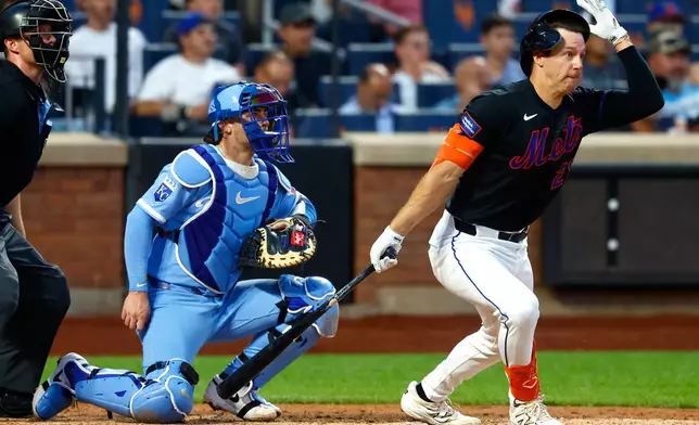 New York Mets' Jared Young grabs his helmet after hitting a pop fly ball for an out against the Kansas City Royals during the fourth inning of a baseball game, Wednesday, July 8, 2026, in New York. (AP Photo/Noah K. Murray)