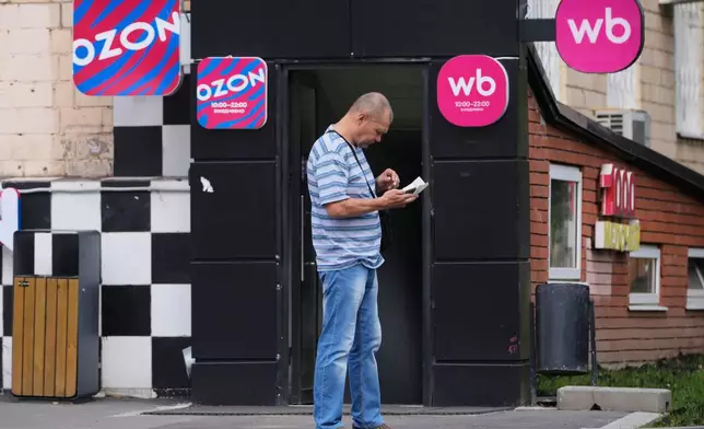A man stands outside an outlet of Wildberries, Russia's major online retailer, in Moscow on Wednesday, July 22, 2026. (AP Photo/Pavel Bednyakov)