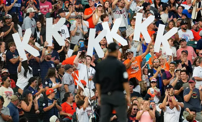 Fans hold up K signs for Detroit Tigers pitcher Tarik Skubal strikeouts against the Kansas City Royals during the eighth inning of a baseball game Friday, July 24, 2026, in Detroit. (AP Photo/Paul Sancya)