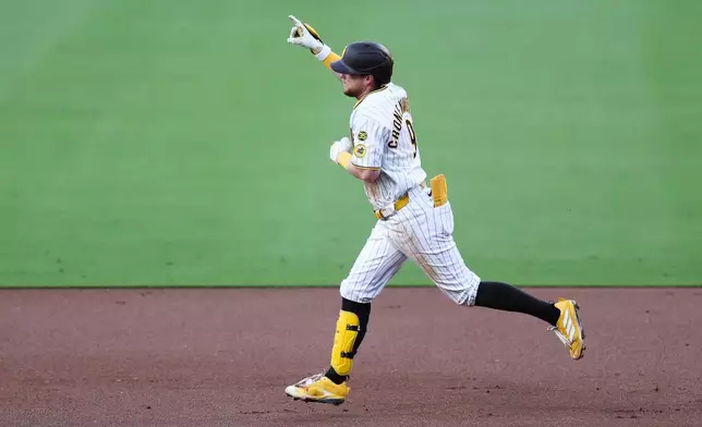 San Diego Padres' Jake Cronenworth gestures to the sky while running the bases after hitting a three-run home run against the Arizona Diamondbacks in the first inning of a baseball game Tuesday, July 7, 2026, in San Diego. (AP Photo/Derrick Tuskan)