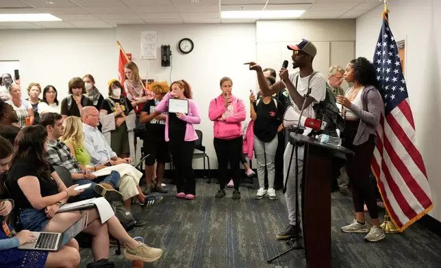 Resident react during a press conference regarding the incident where a man was shot and killed on Wednesday by Madison police, Thursday, July 23, 2026, at the police station in Madison, Wis. (AP Photo/Kayla Wolf)