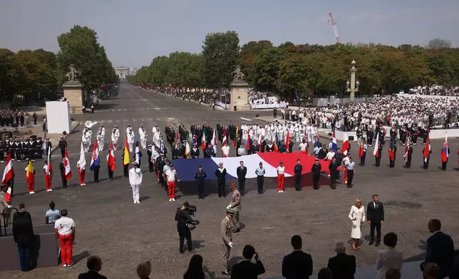 A French flag is on display after the Bastille Day military parade on the Champs-Elysees avenue, in Paris, Tuesday, July 14, 2026. (AP Photo/Michel Euler)