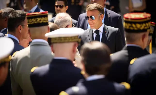 French President Emmanuel Macron greets senior military officers after his traditional address to the armed forces on the eve of the Bastille Day parade at the Ministry of Defense in Paris, Monday, July 13, 2026. (AP Photo/Thomas Padilla, Pool)