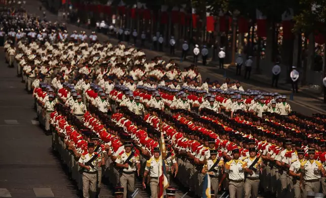 French soldiers march during the Bastille Day military parade on the Champs-Elysees avenue, in Paris, Tuesday, July 14, 2026. (AP Photo/Thomas Padilla)