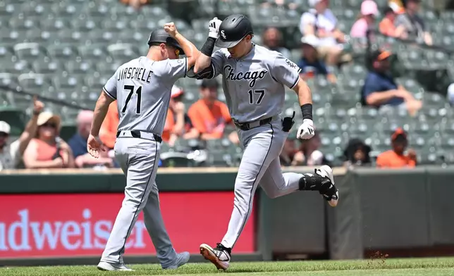 Chicago White Sox left fielder Sam Antonacci (17) is congratulated by Chicago White Sox third base coach (71) after a lead off solo home run against the Baltimore Orioles In the first inning of a baseball game, Wednesday, July 1, 2026 in Baltimore. (AP Photo/Gail Burton)