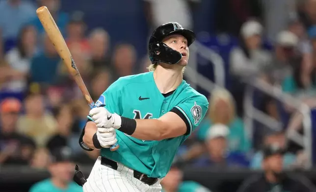 Miami Marlins' Kyle Stowers watches his ball after hitting a home run during the third inning of a baseball game against the San Diego Padres, Sunday, July 26, 2026, in Miami. (AP Photo/Rebecca Blackwell)