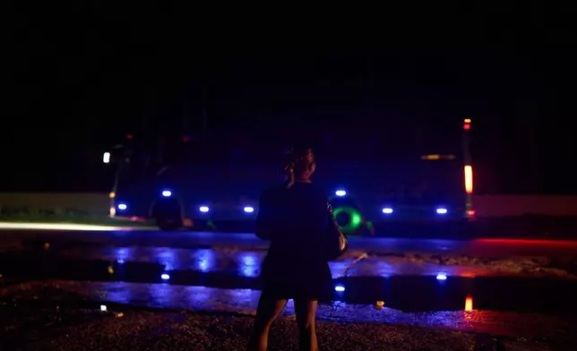A transgender sex worker stands next to a busy highway waiting for clients to approach her in Hetauda, Nepal, Saturday, May 16, 2026. (AP Photo/Bram Janssen)