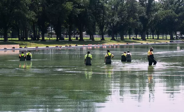 Workers lay nets in the Lincoln Memorial Reflecting Pool to catch debris from the Fourth of July fireworks display, Tuesday, June 30, 2026, in Washington. (AP Photo/Manuel Balce Ceneta)