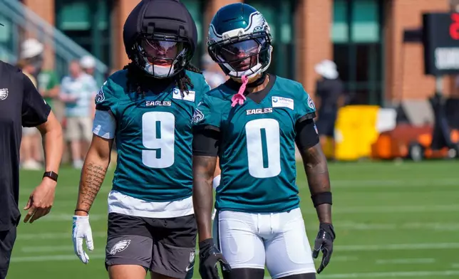 Philadelphia Eagles wide receivers Makai Lemon (9) and Hollywood Brown (0) look on during practice at the team's NFL football training camp in Philadelphia, Wednesday, July 29, 2026. (AP Photo/Chris Szagola)