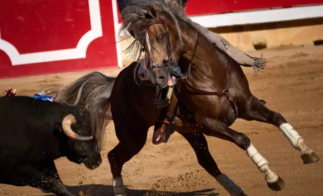 Spanish rejoneador Andy Cartagena performs on horseback during a bullfight at the San Fermín festival in the bullring of Pamplona, northern Spain, Monday, July 6, 2026. (AP Photo/Miguel Oses)
