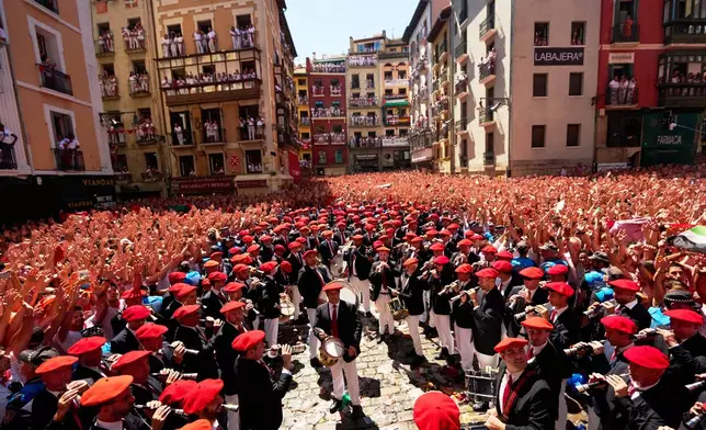 Revelers celebrate as the txupinazo, the traditional rocket marking the start of the San Fermín festival, kicks off nine days of uninterrupted festivities in Pamplona, Spain, Monday, July 6, 2026. (AP Photo/Miguel Oses)