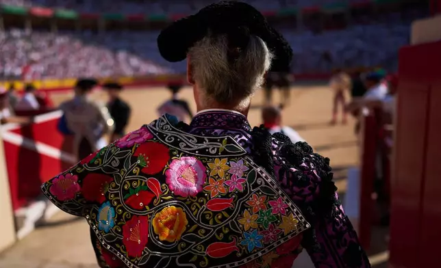 A member of a bullfighter's entourage enters the ring during a bullfight at the San Fermín festival in Pamplona, northern Spain, Tuesday, July 7, 2026. (AP Photo/Miguel Oses)