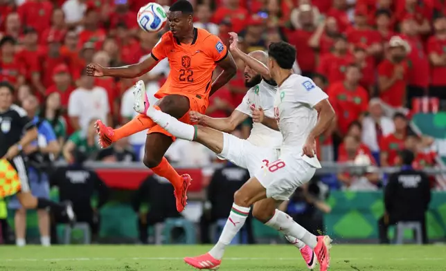 Morocco's Noussair Mazraoui (3) (center) gets a shot off in front of Netherlands' Denzel Dumfries (22) during the World Cup round of 32 soccer match between the Netherlands and Morocco in Guadalupe, near Monterrey, Mexico, Monday, June 29, 2026. (AP Photo/Addison Simmons)