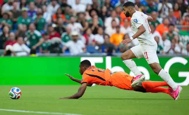 Netherlands' Denzel Dumfries (22) is tripped by Morocco's Ismael Saibari (11) during the World Cup round of 32 soccer match between the Netherlands and Morocco in Guadalupe, near Monterrey, Mexico, Monday, June 29, 2026. (AP Photo/Dolores Ochoa)