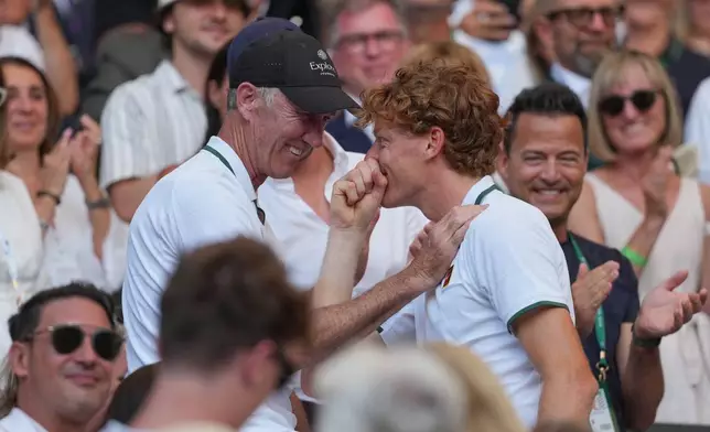 Jannik Sinner of Italy embraces coaches and family after winning the men's singles final, defeating Alexander Zverev of Germany, at Wimbledon Tennis Championships in London, Sunday, July 12, 2026. (AP Photo/Kin Cheung)