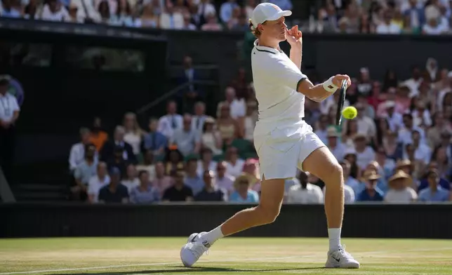Jannik Sinner of Italy stretches to play a return to Alexander Zverev of Germany during the men's singles final at Wimbledon Tennis Championships in London, Sunday, July 12, 2026. (AP Photo/Kin Cheung)