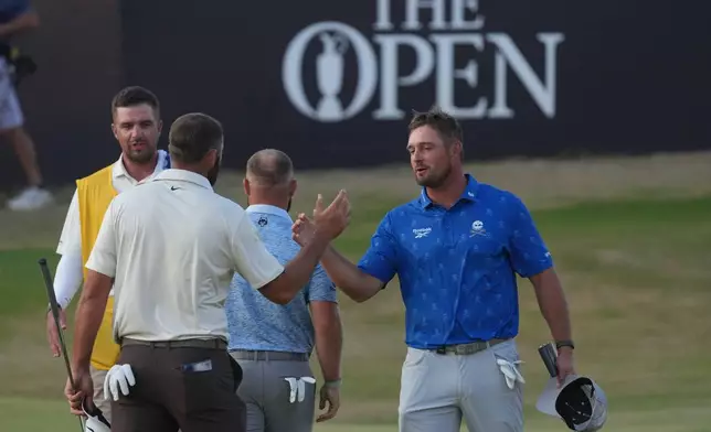 Bryson DeChambeau of the United States, right shakes hands with Scottie Scheffler of the United States after they completed their second rounds on the 18th green during the second day of the British Open Golf championships at Royal Birkdale golf club, in Southport, England, Friday, July 17, 2026. (AP Photo/Jon Super)