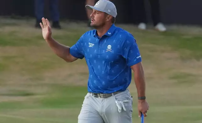 Bryson DeChambeau of the United States acknowledges the crowd after making a birdie putt to conclude his second round on the 18th green during the second day of the British Open Golf championships at Royal Birkdale golf club, in Southport, England, Friday, July 17, 2026. (AP Photo/Jon Super)