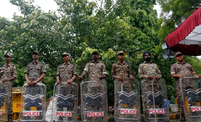 Security officers stand guard at the camping site of the Cockroach Janta Party at Jantar Mantar in New Delhi, Tuesday, July 21, 2026. (AP Photo/Shekhar Yadav)